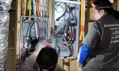 Electrician inspecting EV charger installation site, emphasizing safety standards and permitting requirements